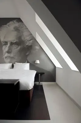 a bedroom with a painting of a man on the wall at Inntel Hotels Amsterdam Zaandam in Zaandam