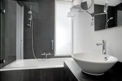 a bathroom with a white tub and a sink at Inntel Hotels Amsterdam Zaandam in Zaandam