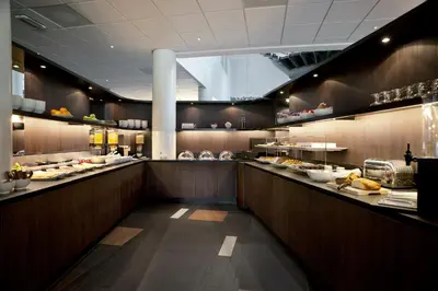 a restaurant with a buffet line with food at Inntel Hotels Amsterdam Zaandam in Zaandam