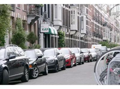 a line of cars parked on a city street at Hotel Kap City Centre in Amsterdam