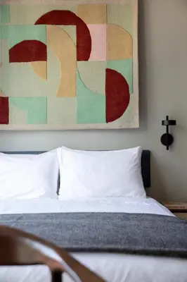 a bedroom with a bed and a painting on the wall at Bob W Amsterdam Noord in Amsterdam