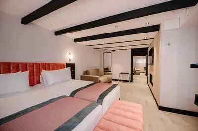 a hotel room with a bed and a couch at Catalonia Vondel Amsterdam in Amsterdam