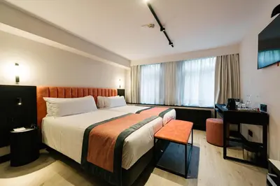 a hotel room with a bed and a desk at Catalonia Vondel Amsterdam in Amsterdam