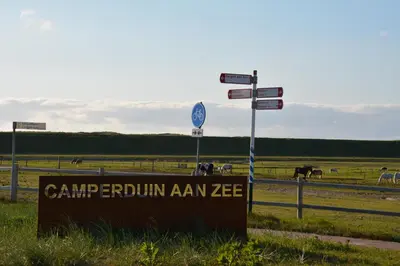 a sign for a farm with horses in a field at Strandhotel Camperduin in Schoorl