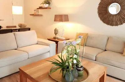 a living room with two couches and a coffee table at Luxury loft at lake Volendam 20 min. from Amsterdam CS in Volendam