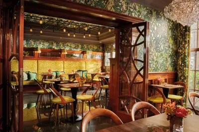 a restaurant with tables and chairs in a room at Hotel Estheréa in Amsterdam