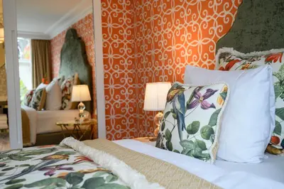 a bedroom with a bed with a pillow and a wall at Hotel Estheréa in Amsterdam