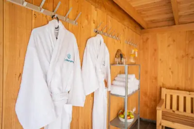 a room with white towels hanging on a wooden wall at Sunny Trio in Zeewolde
