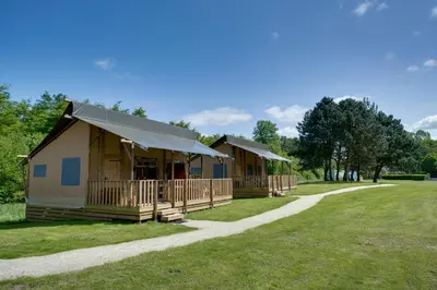 a row of cottages in a park with a path at Sunny Trio in Zeewolde