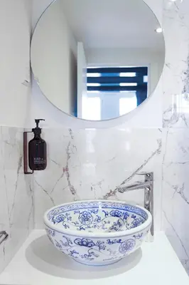 a blue and white sink in a bathroom with a mirror at Boutique Hotel des Arts in Amsterdam