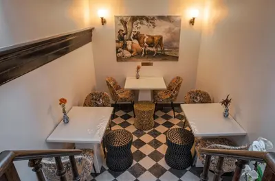 a restaurant with two tables and chairs and a checkered floor at Boutique Hotel des Arts in Amsterdam