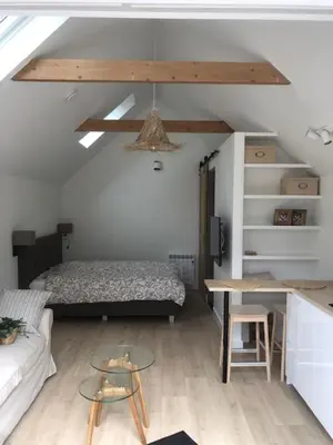 a bedroom with a bed and a table and a couch at Dune Vieuw in Zandvoort