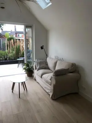 a living room with a couch and a table at Dune Vieuw in Zandvoort