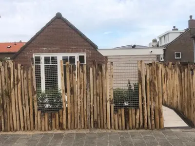 a wooden fence in front of a house at Dune Vieuw in Zandvoort