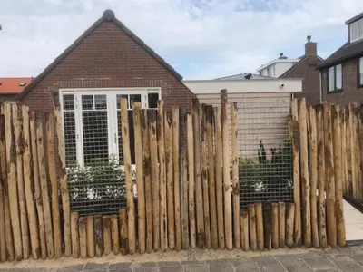 a wooden fence in front of a house at Dune Vieuw in Zandvoort