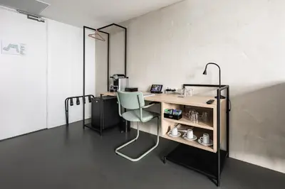 a room with a desk and a chair in it at Gooiland Hotel in Hilversum