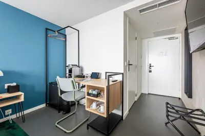 an office with a desk and chairs and a mirror at Gooiland Hotel in Hilversum