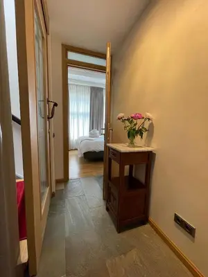a hallway with a table with a vase of flowers on it at Amsterdam-bnb in Amsterdam