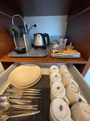 a drawer with plates and utensils in a kitchen at Amsterdam-bnb in Amsterdam