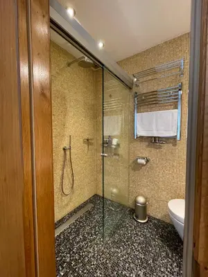 a bathroom with a glass shower with a toilet at Amsterdam-bnb in Amsterdam