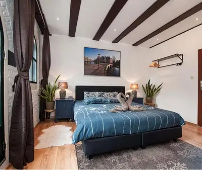 a bedroom with a bed with two swans on it at Crown Guesthouse Amsterdam in Amsterdam