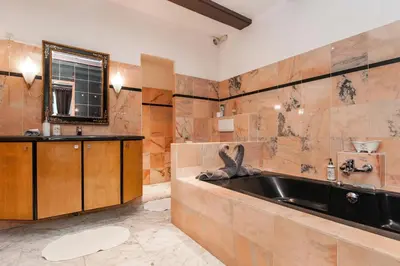 a bathroom with a large tub and a sink at Crown Guesthouse Amsterdam in Amsterdam