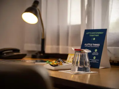 a desk with a coffee maker and a book on it at Campanile Hotel & Restaurant Gouda in Gouda
