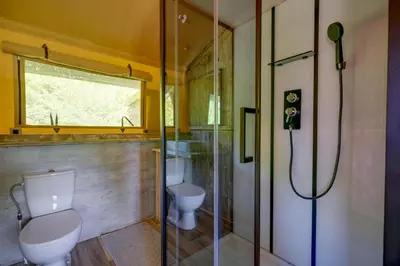 a bathroom with a toilet and a glass shower at Sunny Lodge 6 persoons in Zeewolde