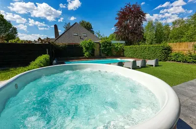 a hot tub in a backyard with a pool at Sunny Lodge 6 persoons in Zeewolde
