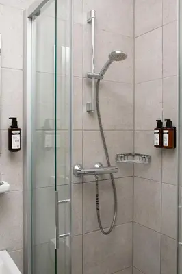 a shower with a glass door in a bathroom at Hotel La Bohème in Amsterdam