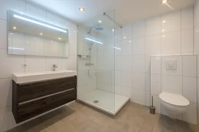 a bathroom with a shower and a toilet and a sink at Boutique Hotel Chariot - Amsterdam Schiphol Airport in Aalsmeer