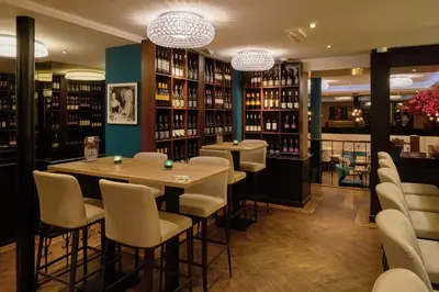 a restaurant with a table and chairs in a library at Boutique Hotel Chariot - Amsterdam Schiphol Airport in Aalsmeer