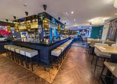 a bar in a restaurant with bar stools at Boutique Hotel Chariot - Amsterdam Schiphol Airport in Aalsmeer