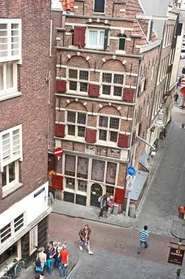 a group of people standing in front of a building at Koopermoolen in Amsterdam