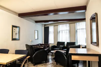 a waiting room with leather chairs and tables at Koopermoolen in Amsterdam
