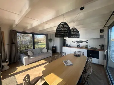 a living room with a table and a couch at Surla Houseboat 