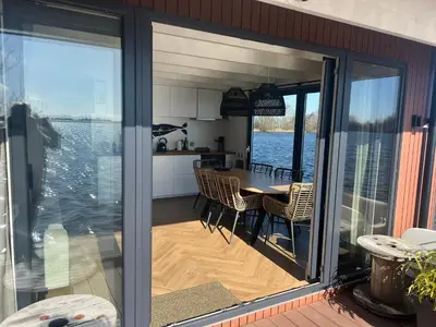 a kitchen and dining room with a view of the water at Surla Houseboat 