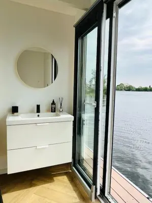 a bathroom with a sink and a large window at Surla Houseboat 