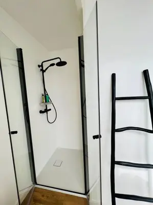 a shower in a bathroom with a glass wall at Surla Houseboat 