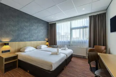 a hotel room with a bed and a desk at Best Western Amsterdam in Amsterdam
