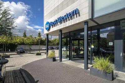 a building with a sign for a car dealership at Best Western Amsterdam in Amsterdam