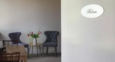 a dining room with blue chairs and a table at De Dinkelhoeve in Heemstede