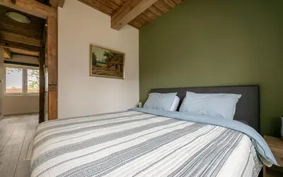 a bedroom with a large bed in a room at De Dinkelhoeve in Heemstede