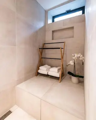 a bathroom with a shelf with towels and a window at Beautiful Amstel houseboat in Amsterdam