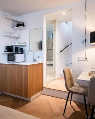 a kitchen with a sink and a counter with a microwave at Beautiful Amstel houseboat in Amsterdam
