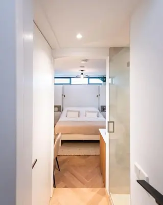 a bedroom with a bed and a window in a room at Beautiful Amstel houseboat in Amsterdam