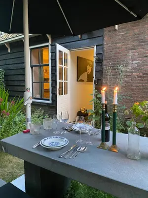 a table with wine glasses and candles on it at Ingeborgh Art Gastenverblijf in Grootschermer