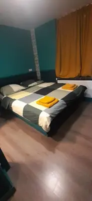 a bedroom with a bed with yellow towels on it at JONI, not for parties, not a hotel, room with no kitchen in Amsterdam