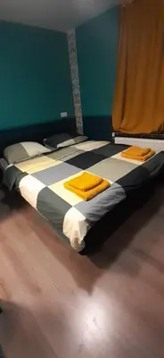 a bed in a room with yellow towels on it at JONI, not for parties, not a hotel, room with no kitchen in Amsterdam