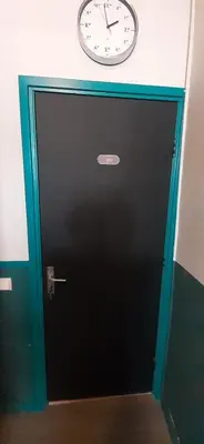 a black door with a clock on top of it at JONI, not for parties, not a hotel, room with no kitchen in Amsterdam